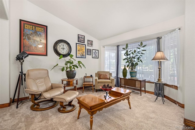 sitting room with baseboards, vaulted ceiling, and carpet flooring