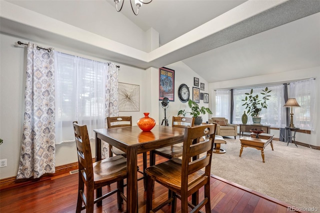 dining room featuring lofted ceiling, dark hardwood / wood-style floors, and a notable chandelier