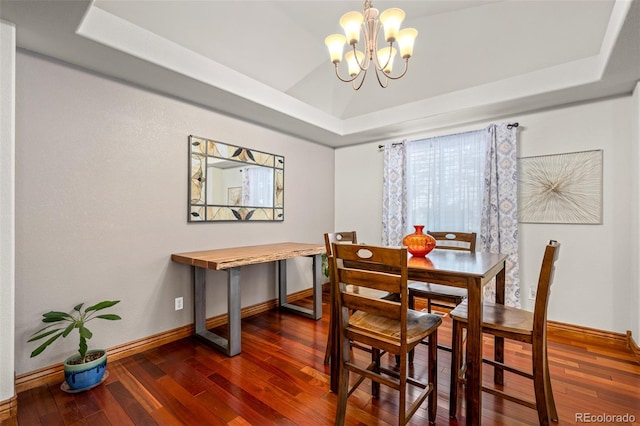 dining room featuring a chandelier, a tray ceiling, wood-type flooring, and lofted ceiling