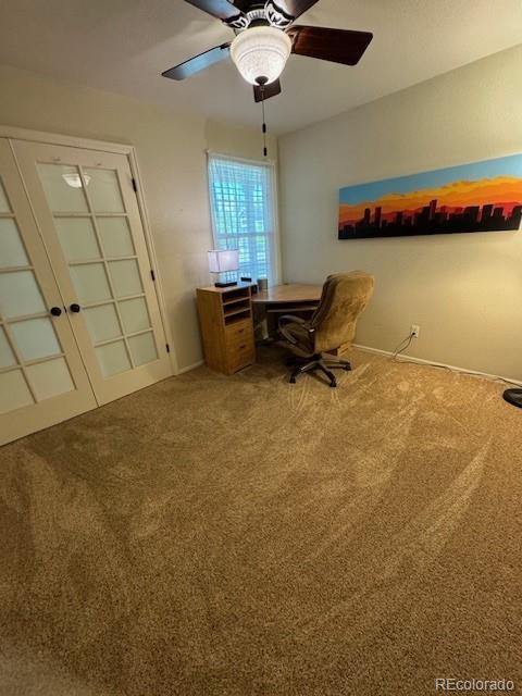 home office featuring ceiling fan, carpet, and french doors