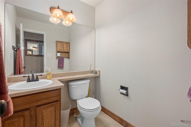 bathroom featuring toilet, tile patterned flooring, and vanity