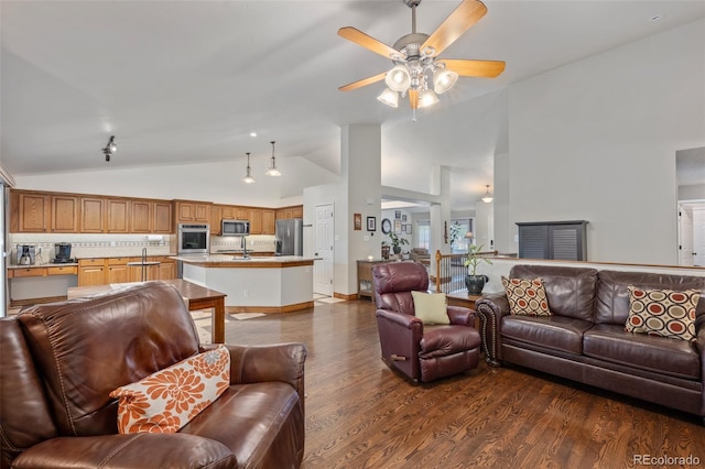 living room with ceiling fan, sink, dark hardwood / wood-style floors, and high vaulted ceiling