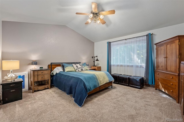 bedroom featuring a ceiling fan, lofted ceiling, and light colored carpet