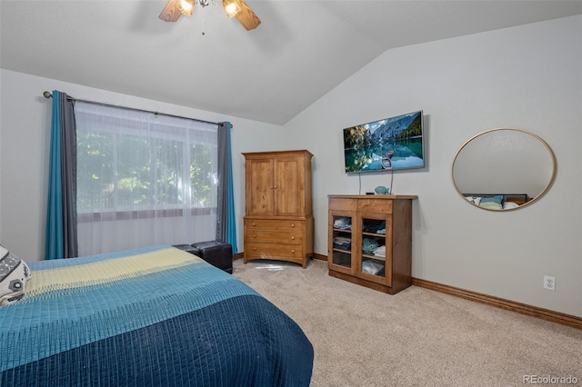 bedroom with ceiling fan, baseboards, vaulted ceiling, and light colored carpet