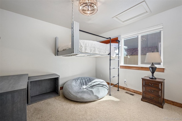 bedroom with carpet, attic access, visible vents, and baseboards