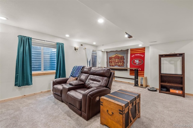 carpeted cinema room with recessed lighting and baseboards