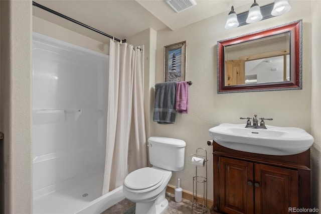 bathroom with toilet, vanity, and a shower with curtain