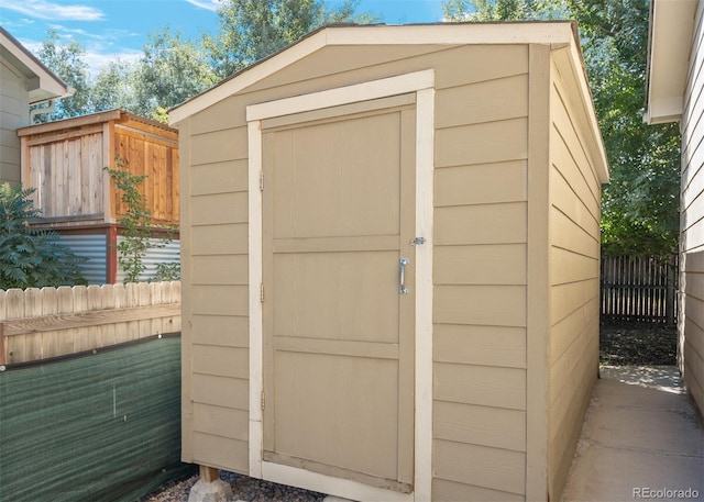 view of shed featuring fence