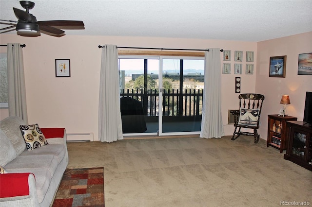 interior space with a baseboard heating unit, a textured ceiling, carpet, and a ceiling fan