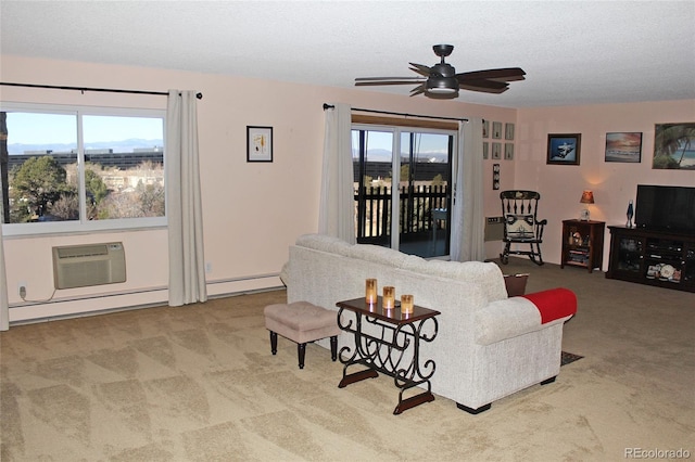 living area with ceiling fan, carpet, plenty of natural light, and a wall mounted AC