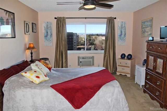 bedroom featuring carpet floors, ceiling fan, a textured ceiling, and a wall mounted AC