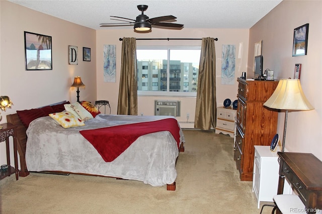 bedroom with a textured ceiling, light carpet, a baseboard heating unit, a ceiling fan, and a wall mounted AC