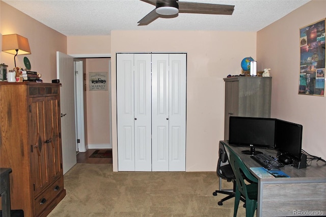 office with carpet floors, a ceiling fan, and a textured ceiling