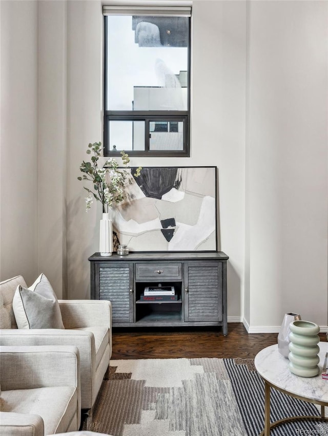 sitting room with dark wood-style floors and baseboards