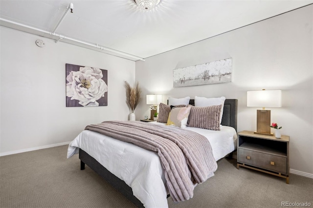 carpeted bedroom featuring baseboards