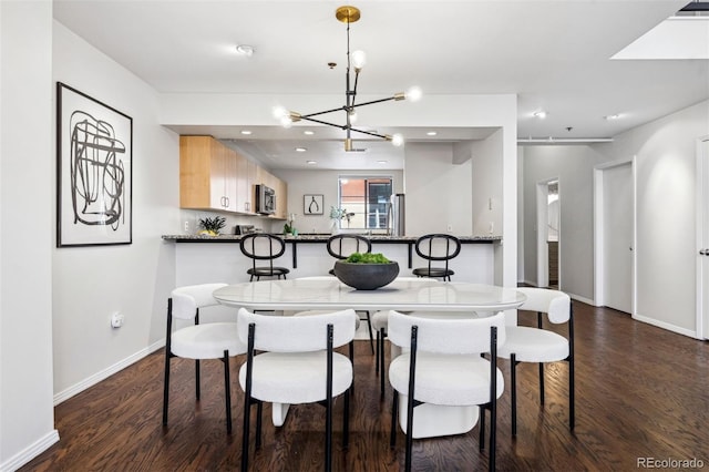 dining area with dark wood-style floors, a chandelier, baseboards, and recessed lighting