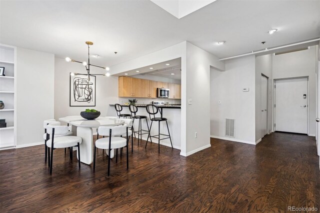 dining space with wood finished floors, a chandelier, recessed lighting, and baseboards