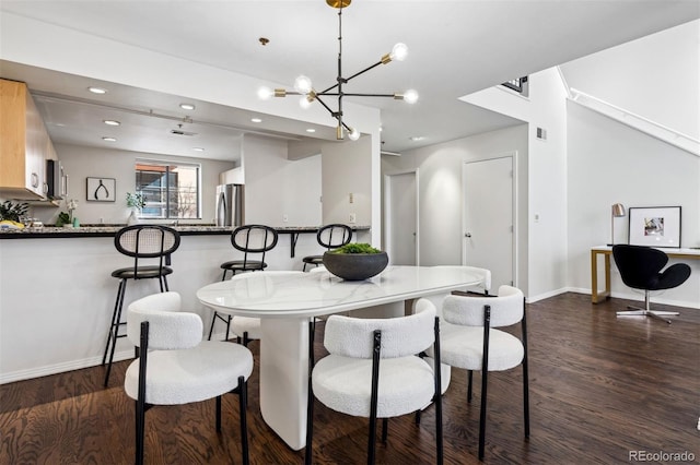 dining room featuring dark wood-type flooring, baseboards, a chandelier, and recessed lighting