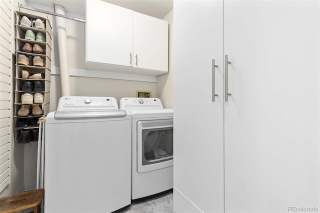 laundry area featuring independent washer and dryer and cabinet space
