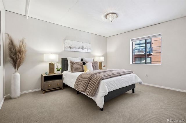 carpeted bedroom featuring baseboards