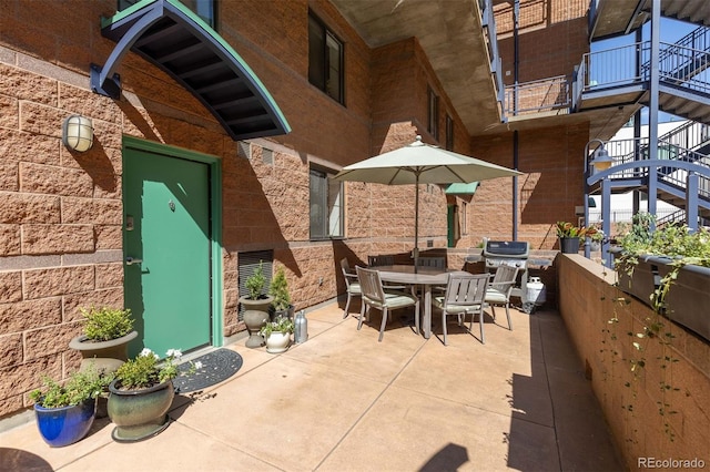 view of patio / terrace with outdoor dining space, stairs, and area for grilling