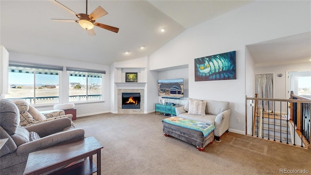 carpeted living room with high vaulted ceiling, a fireplace, baseboards, and ceiling fan