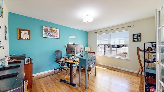 office with baseboards and wood finished floors