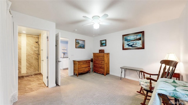 living area with light colored carpet, baseboards, and ceiling fan