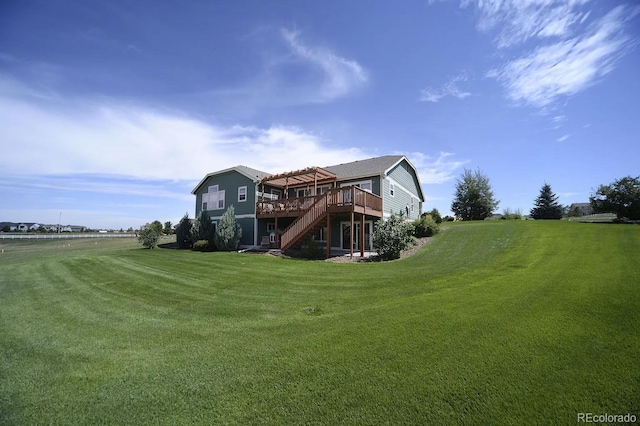 back of property with stairway, a lawn, and a deck