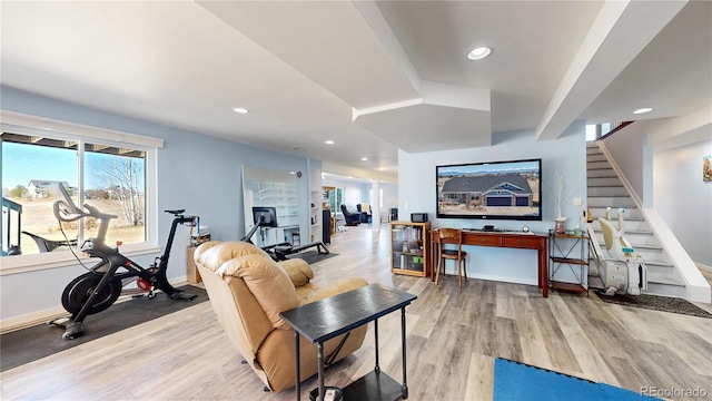 living area featuring stairway, recessed lighting, baseboards, and wood finished floors