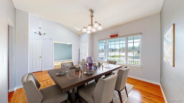 14701 Yosemite St, Brighton, CO 80602 - dining space with a chandelier, light wood-style flooring, baseboards, and vaulted ceiling