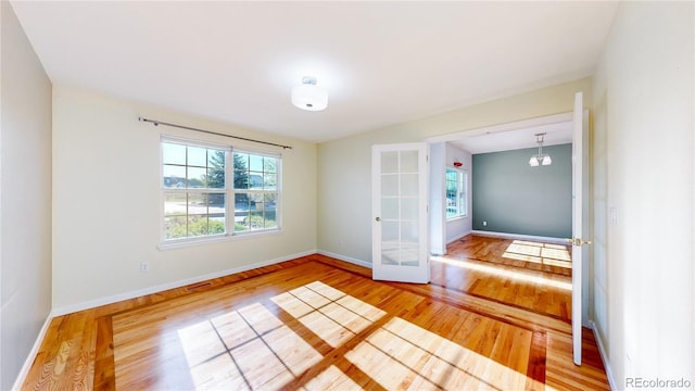 14701 Yosemite St, Brighton, CO 80602 - unfurnished room featuring wood finished floors, french doors, and baseboards
