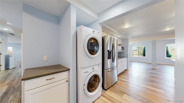 14701 Yosemite St, Brighton, CO 80602 - laundry area featuring stacked washing machine and dryer, light wood finished floors, baseboards, and recessed lighting