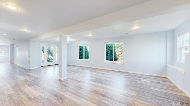 14701 Yosemite St, Brighton, CO 80602 - unfurnished living room with healthy amount of natural light, light wood-style flooring, baseboards, recessed lighting, and decorative columns