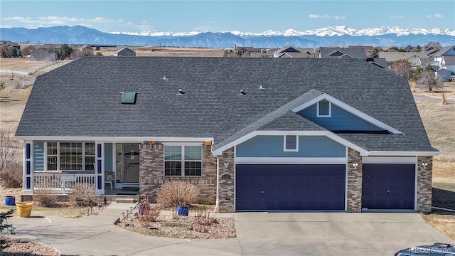 14701 Yosemite St, Brighton, CO 80602 - view of front of house featuring a porch, an attached garage, concrete driveway, roof with shingles, and a mountain view
