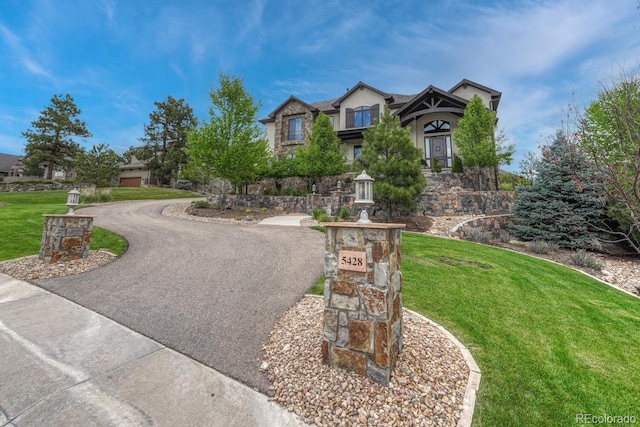 5428 Forest View Rd, Parker, CO 80134 - view of front of property featuring a front lawn, stucco siding, curved driveway, and stone siding