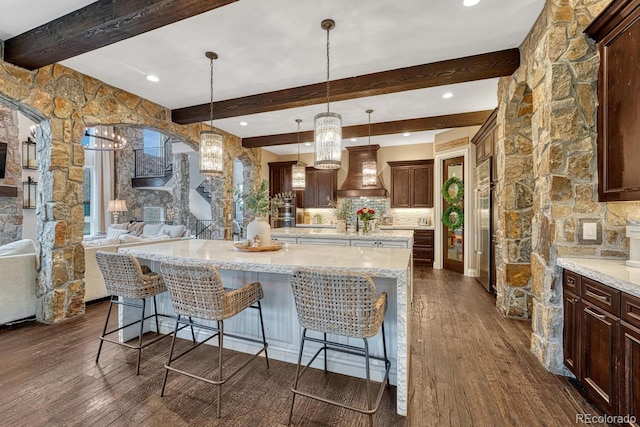 5428 Forest View Rd, Parker, CO 80134 - kitchen featuring custom range hood, beam ceiling, open floor plan, dark wood-type flooring, and a spacious island