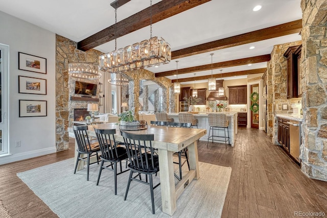 5428 Forest View Rd, Parker, CO 80134 - dining space featuring beamed ceiling, wood finished floors, baseboards, a fireplace, and recessed lighting