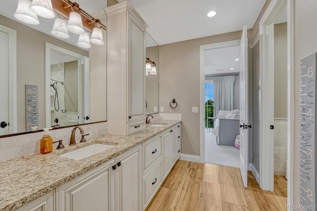 5428 Forest View Rd, Parker, CO 80134 - full bath featuring double vanity, wood finished floors, a shower, and ensuite bathroom