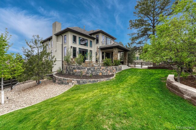 5428 Forest View Rd, Parker, CO 80134 - back of property with a chimney, stucco siding, and a balcony