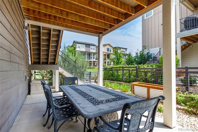 8958 Southurst St, Littleton, CO 80129 - view of patio / terrace featuring outdoor dining space, fence, and stairs