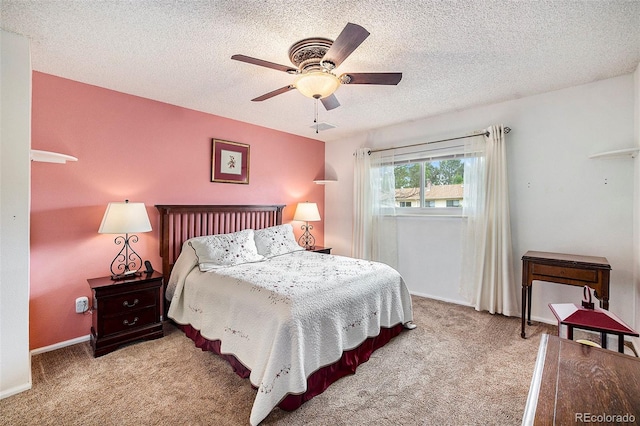 carpeted bedroom with baseboards, a textured ceiling, and a ceiling fan