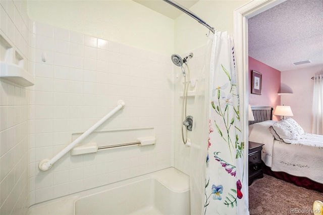 bathroom with curtained shower, visible vents, ensuite bathroom, and a textured ceiling