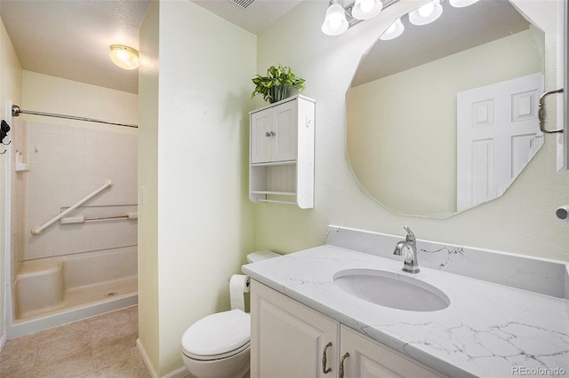 full bathroom featuring vanity, baseboards, a shower, tile patterned floors, and toilet