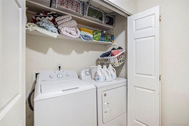 clothes washing area with washer and dryer and laundry area