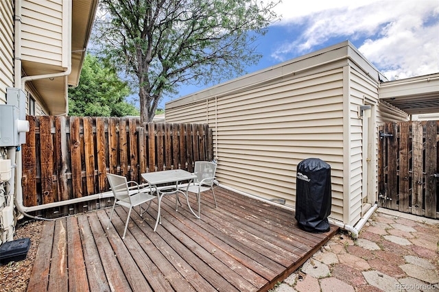 wooden terrace with fence and grilling area