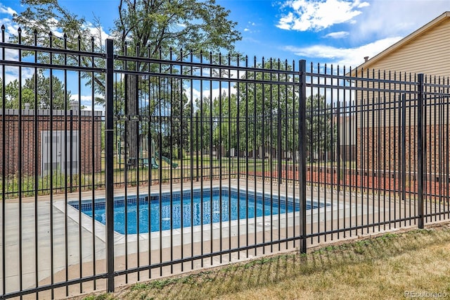 view of pool featuring fence