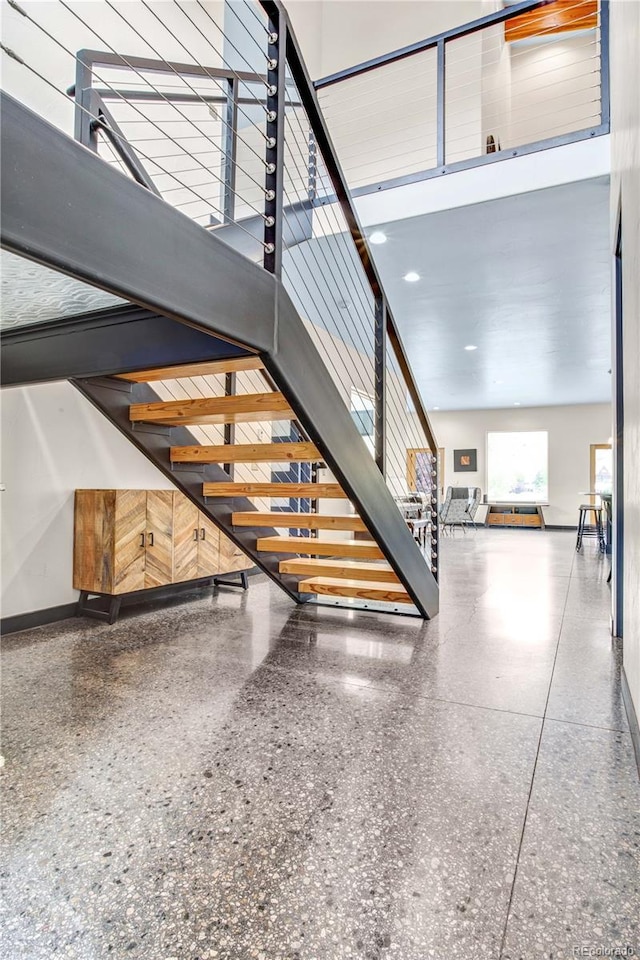 stairs featuring a high ceiling