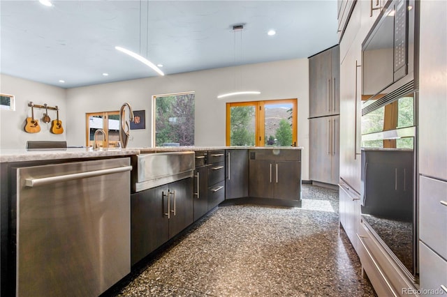 kitchen with stainless steel dishwasher, dark brown cabinets, black microwave, and a wealth of natural light