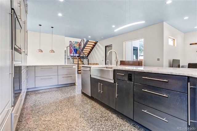 kitchen with dishwasher, decorative light fixtures, and sink